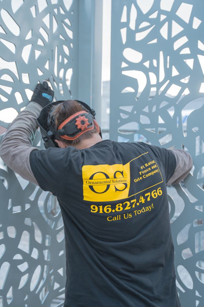 Ornamental Solutions crew member welding in the field
