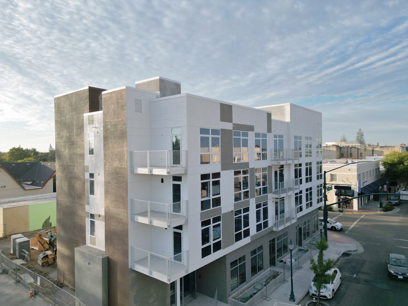 Completed four-story building with steel balcony railings