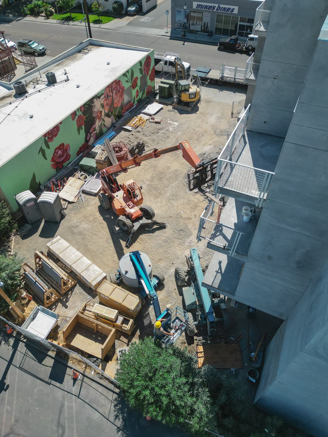 Aerial view of an active Ornamental Solutions jobsite with lifts and staged materials