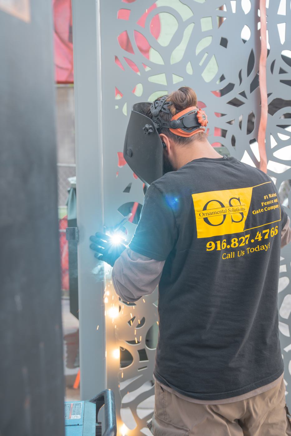 Ornamental Solutions fabricator welding a decorative steel screen panel